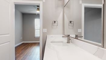 A bathroom with a large mirror and a sink